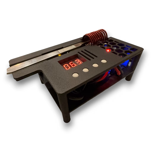 Automatic induction sterilizer with scalpel resting on top and digital display and coils on a black background