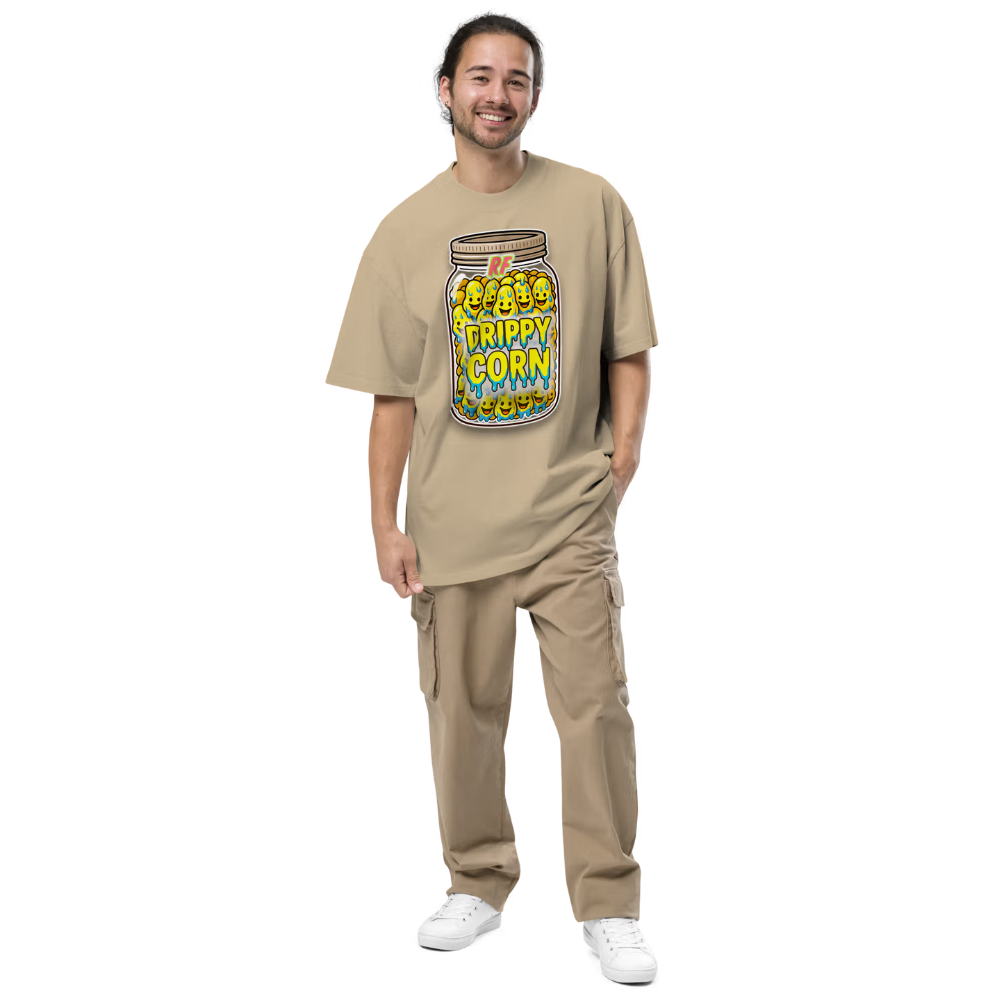 Person wearing a faded khaki oversized t-shirt with a 'Drippy Corn' graphic design