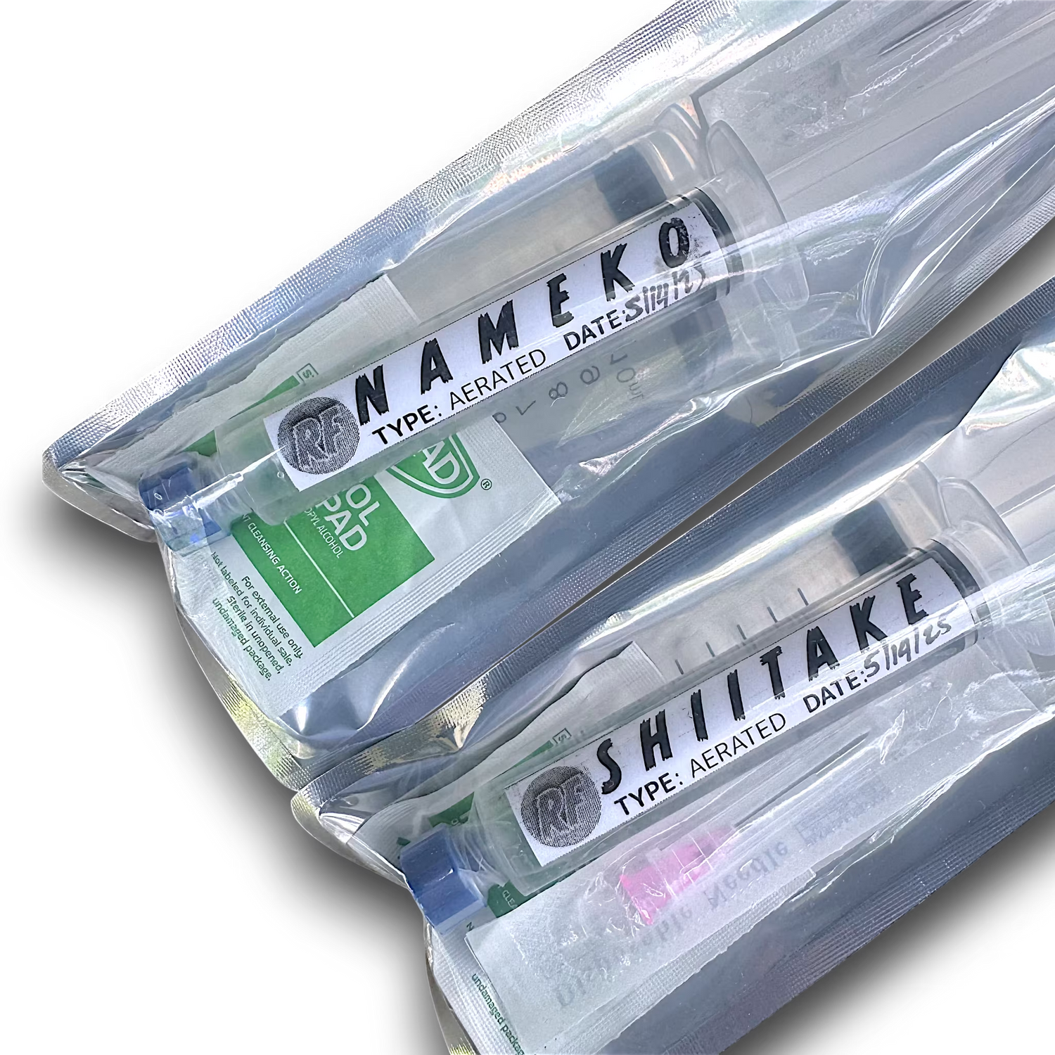 Aerated liquid cultures of Nameko and Shiitake mushrooms in syringes.