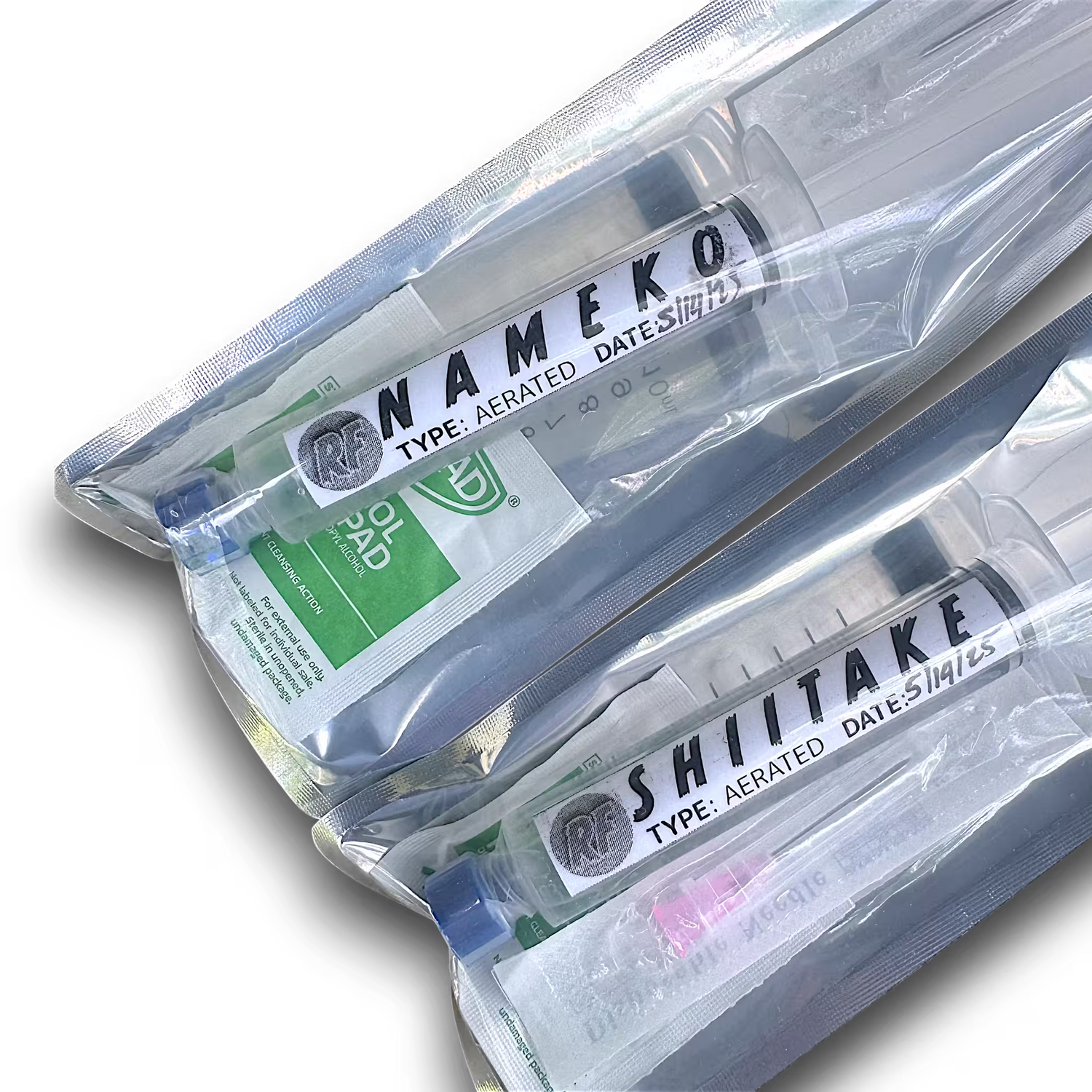 Aerated liquid cultures of Nameko and Shiitake mushrooms in syringes.