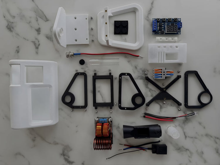 A photo of all the internal parts and pieces of a white mycology and lab tool sterilizer on a white gradient background