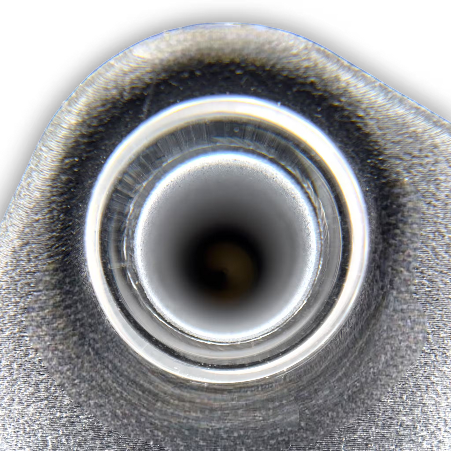 Close-up of glass and central circular opening of an induction sterilizer on a black background