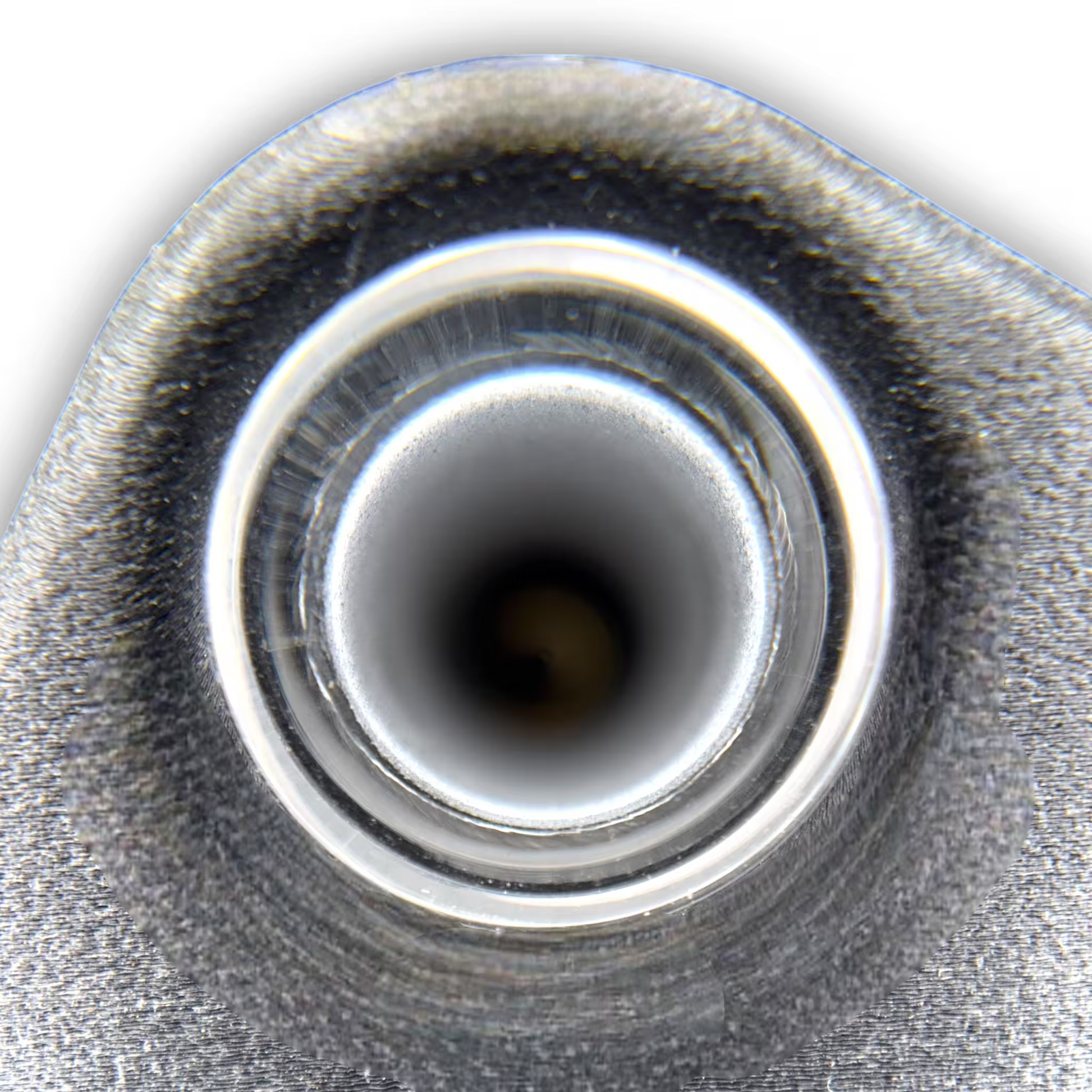 Close-up of glass and central circular opening of an induction sterilizer on a black background