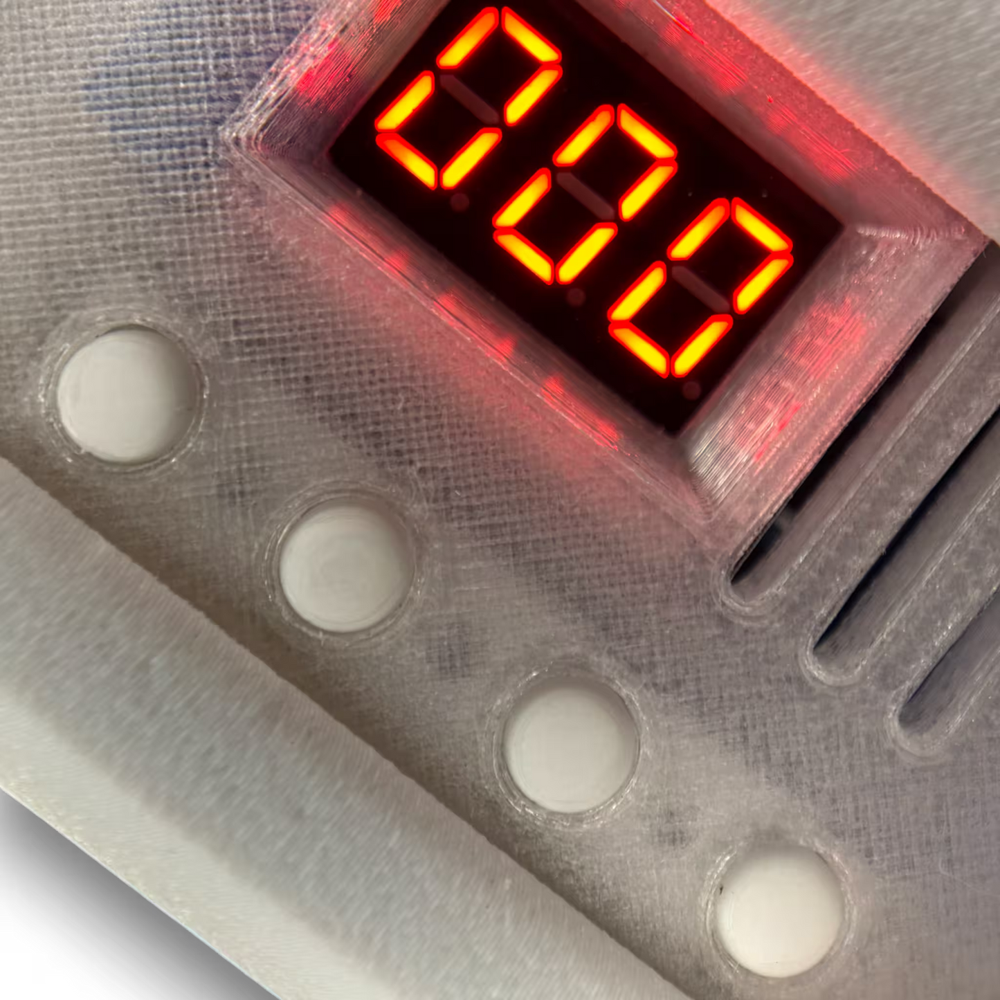 Digital display of a induction sterilizer with red LED digits on a metallic surface