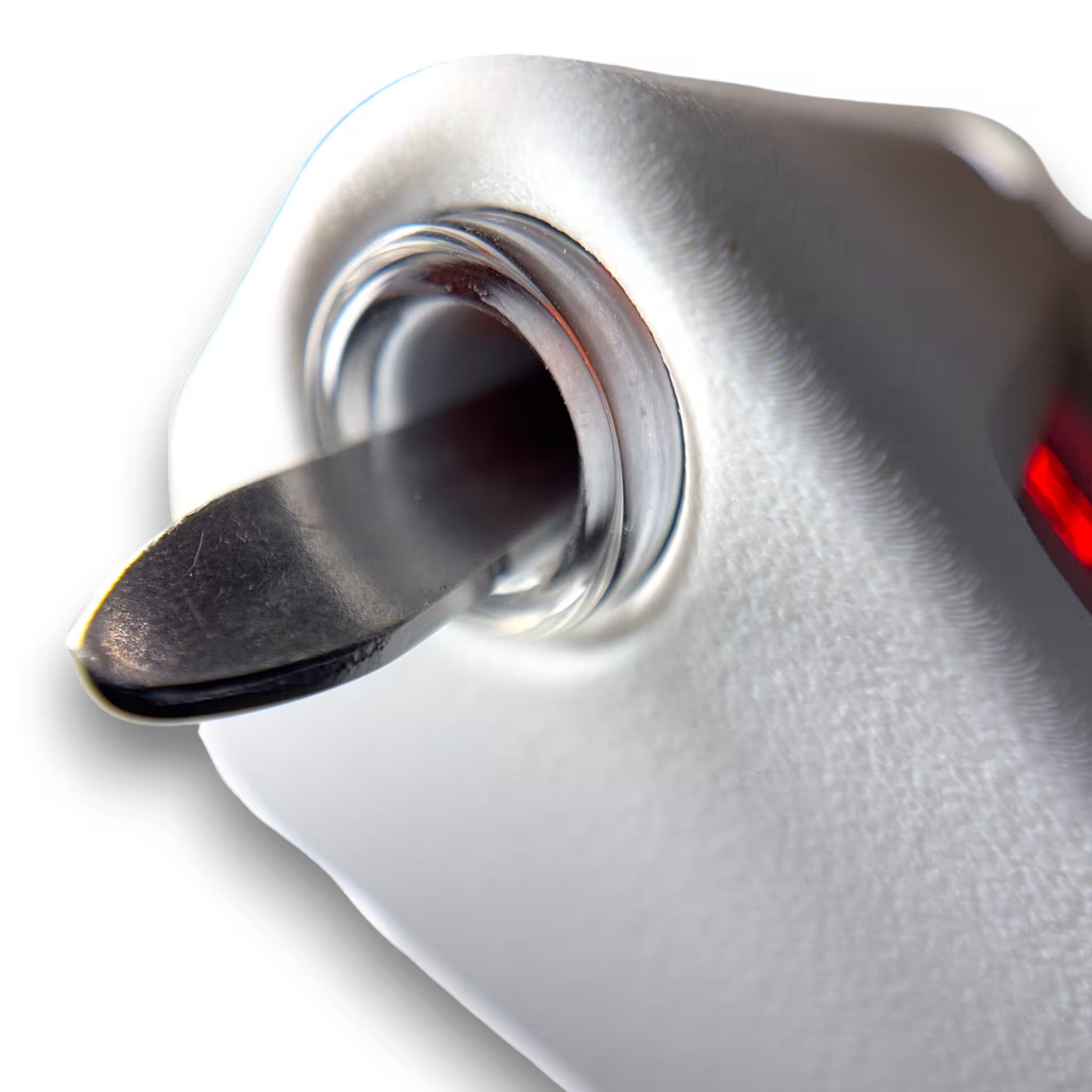 Close-up of a sterile instrument resting inside a induction sterilizer on a white background