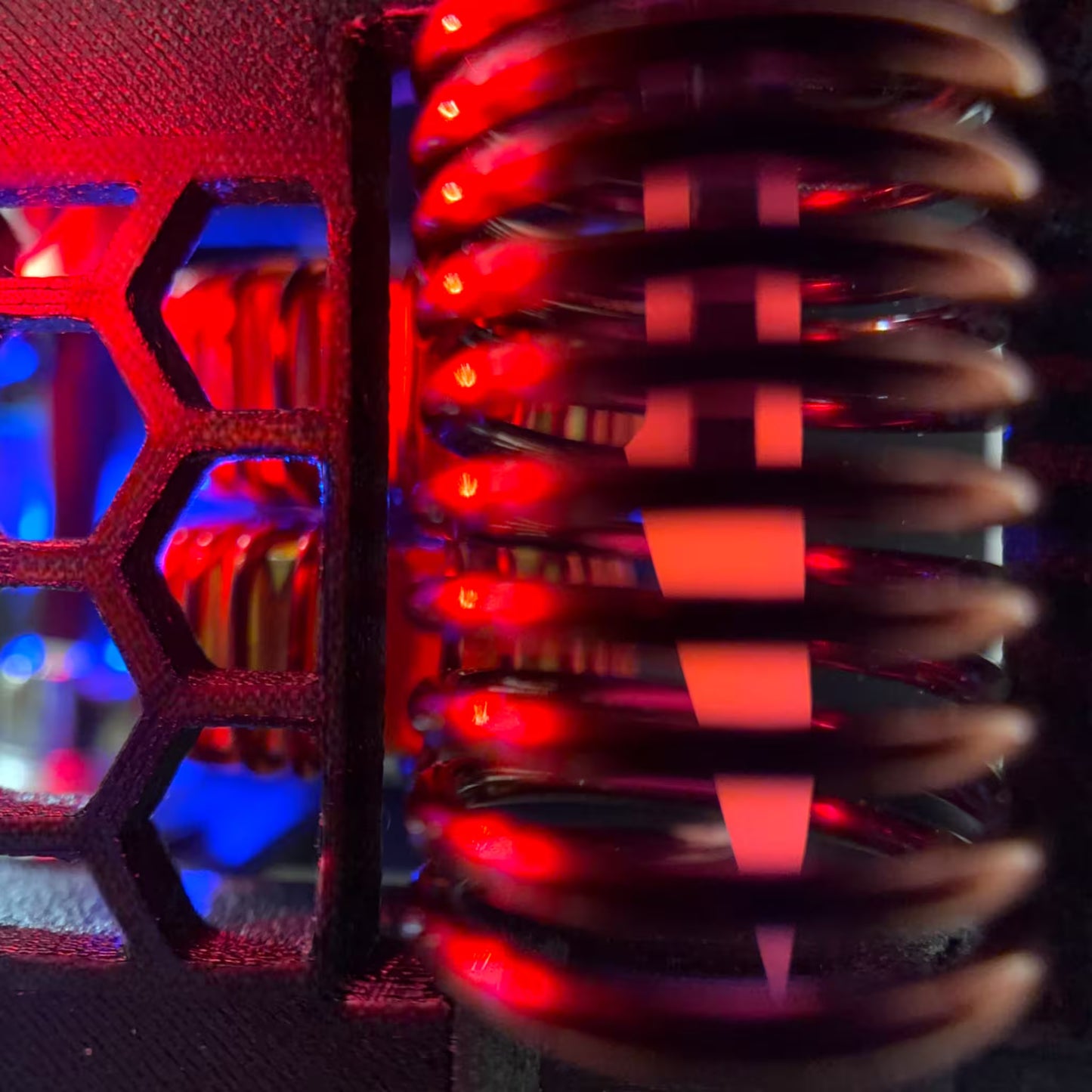 Close-up induction sterilizer's coil. inside a scalpel is being sterilized red hot and a blue LED the background