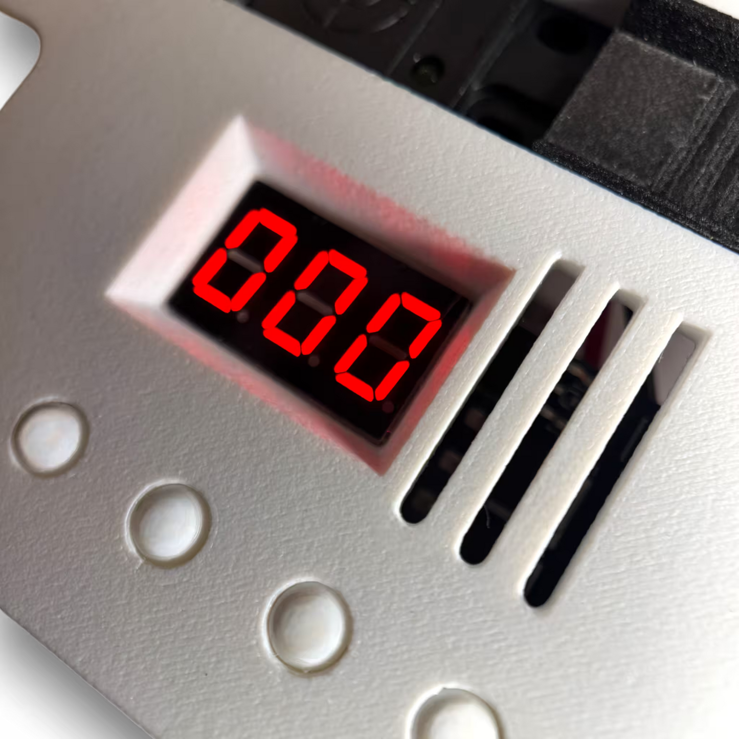 White automatic induction sterilizer with a Digital display with red LED numbers and four buttons on a white background