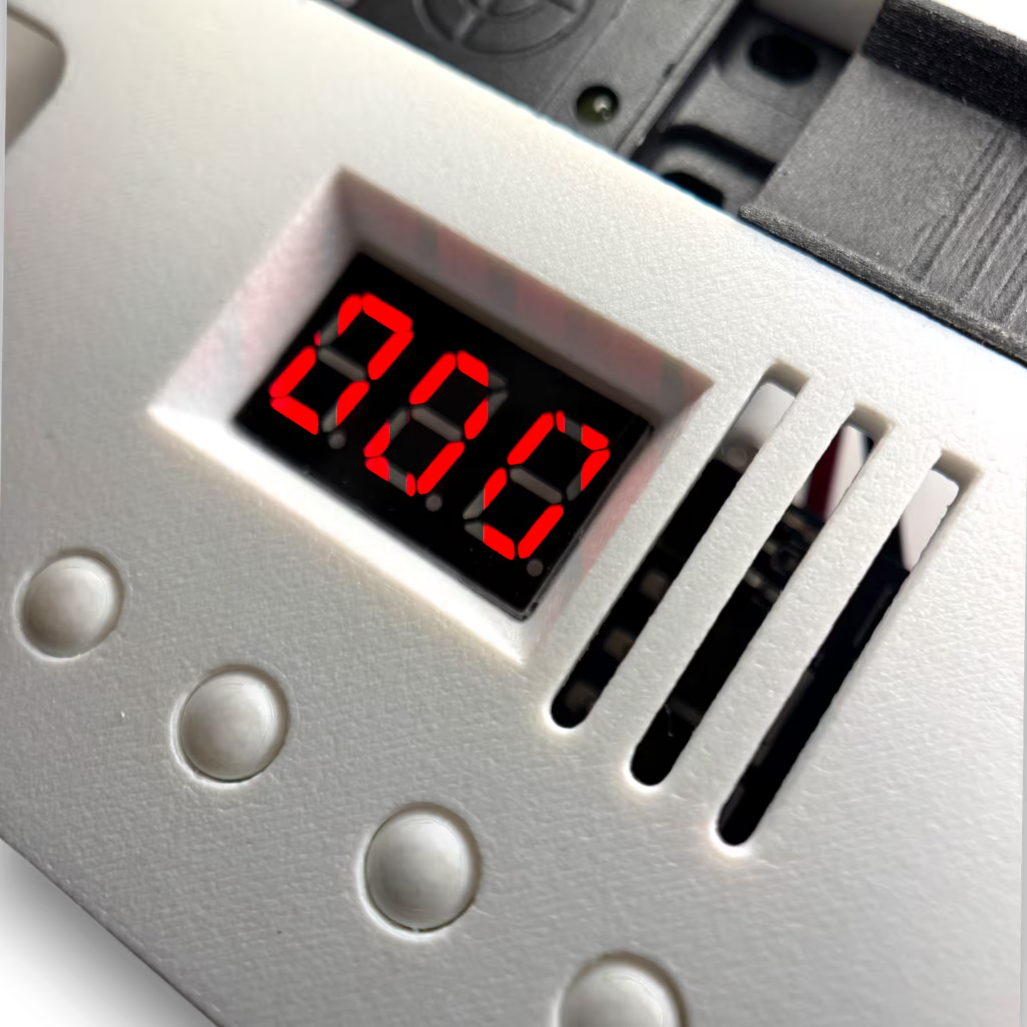 White automatic induction sterilizer with digital display and red LED numbers and white buttons on a white background