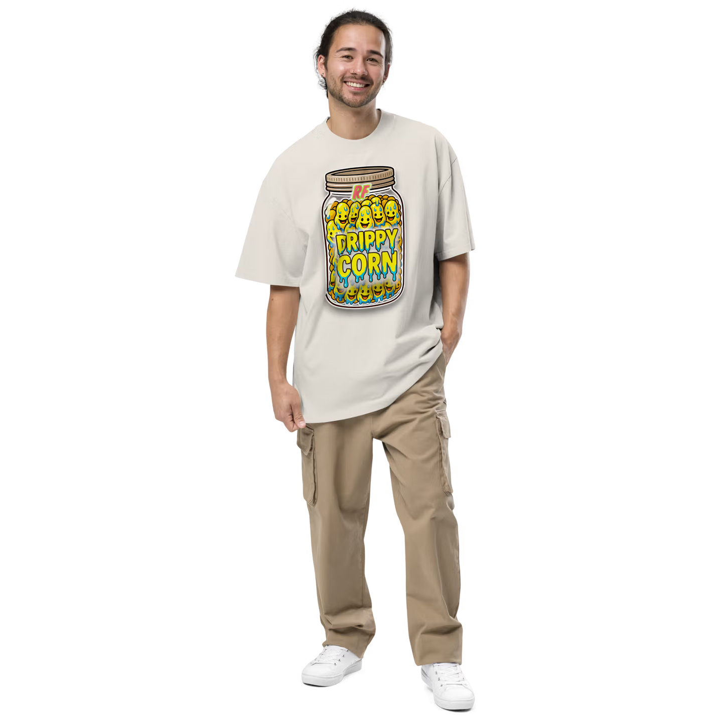 Person wearing a faded bone oversized t-shirt with 'Drippy Corn' design